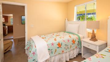 Cozy bedroom with a single bed, bedside table, and lamp.