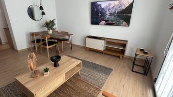 Departamento Premium, 1 cama King size | Área de sala de estar | Televisión de pantalla plana