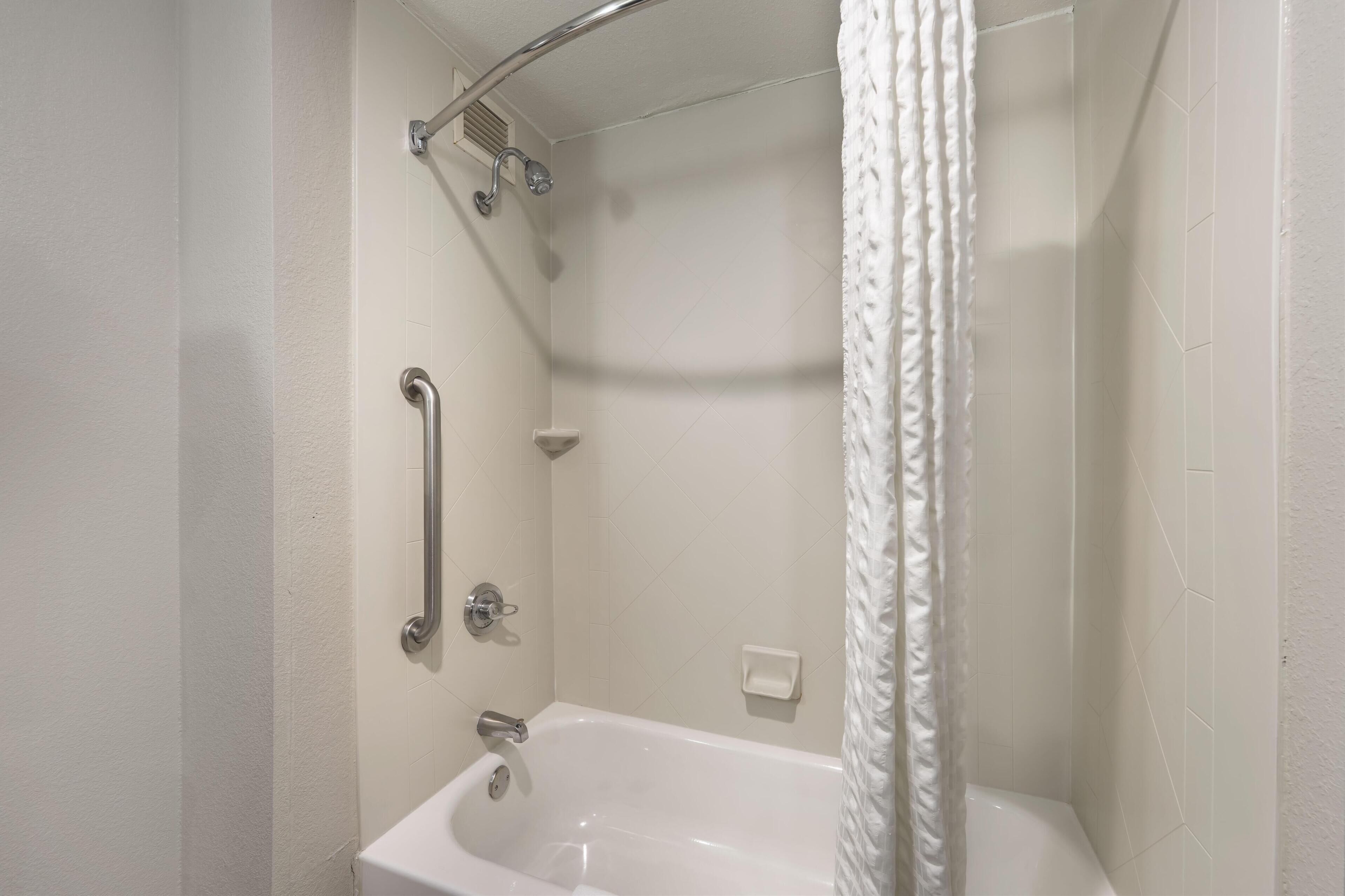 suite, 1 king bed, non smoking, refrigerator & microwave | bathroom | combined shower/bathtub, free toiletries, hair dryer, towels