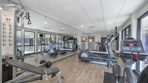 A gym with various exercise equipment, including treadmills, elliptical machines, and weight machines. - Best Western Plus Castlerock Inn & Suites (Bentonville)