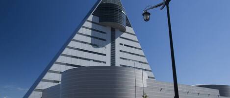 A modern building with a triangular roof and a curved base.