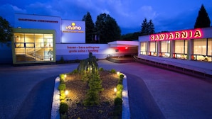 A building with signage for 'Sanatorium Uzdrowiskowe' and 'Kawiarnia'. - Verano (Kolobrzeg)