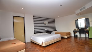 A hotel room with a bed, a desk, and a chair. - Oriental Hotel (George Town)