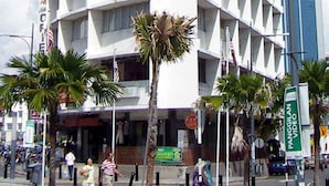 A white, multi-story hotel with a distinctive geometric facade. - Oriental Hotel (George Town)