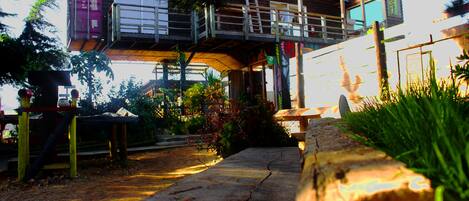 A multi-level outdoor structure with a wooden deck and a metal staircase.