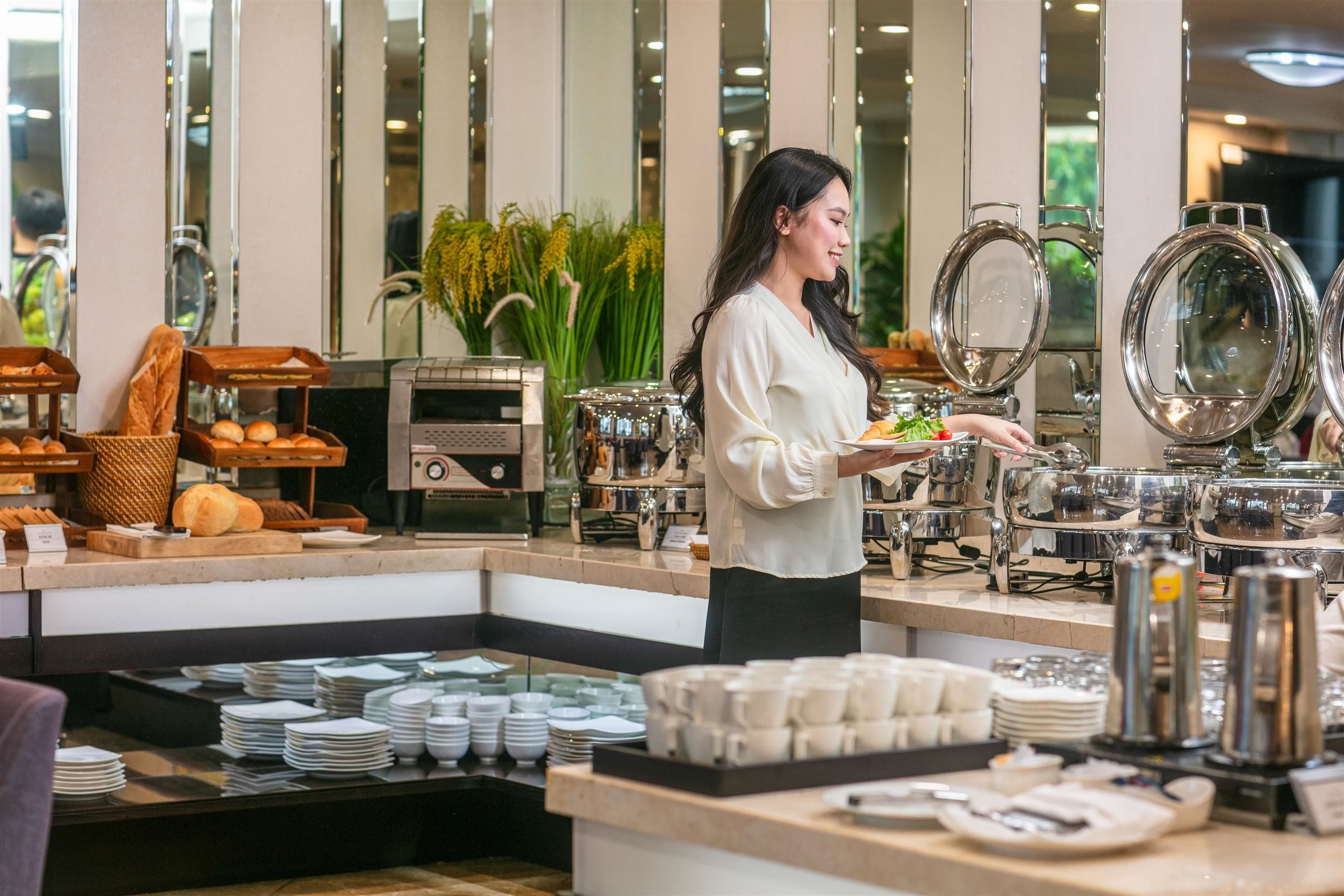 A buffet area with various food items and a buffet station.