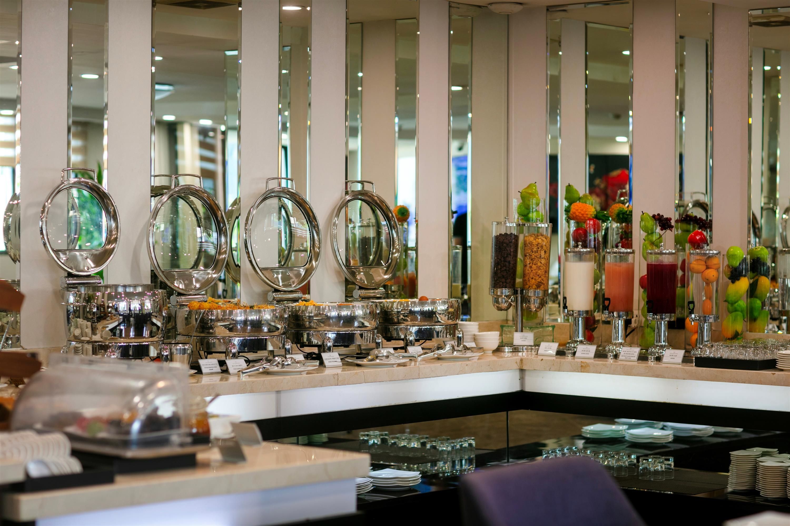 A buffet setup with multiple serving stations, including a variety of food and drink options.