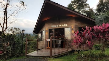 A reception building with a wooden deck and a sign indicating it's open.