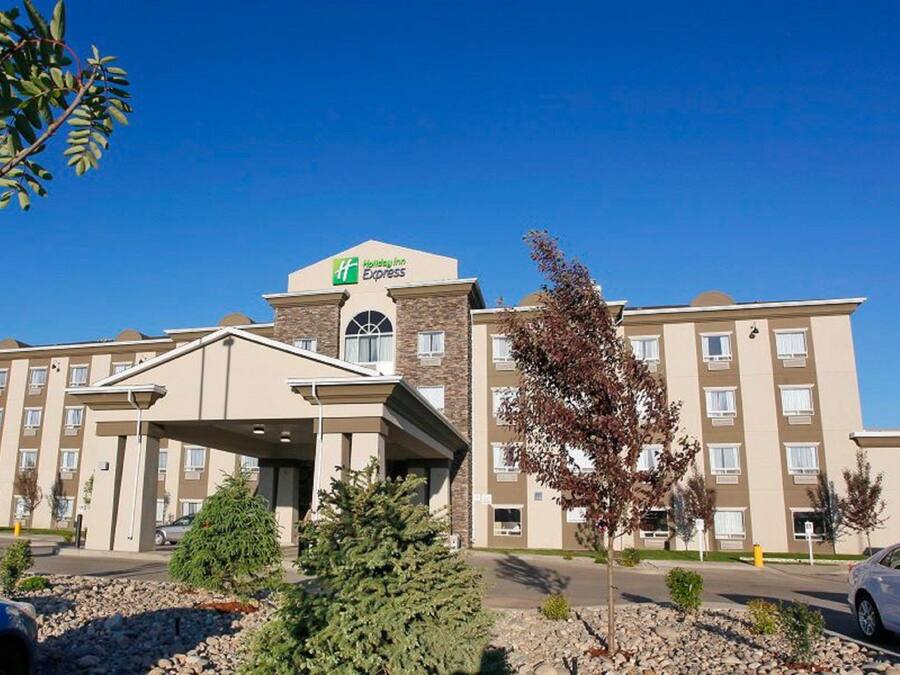 A Holiday Inn Express hotel with a central entrance, multiple floors, and a parking area.