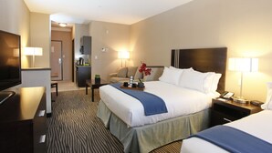 A hotel room with a large bed, a desk, a chair, a TV, and a kitchenette. - Holiday Inn Express Fort St John by IHG (Fort St. John)