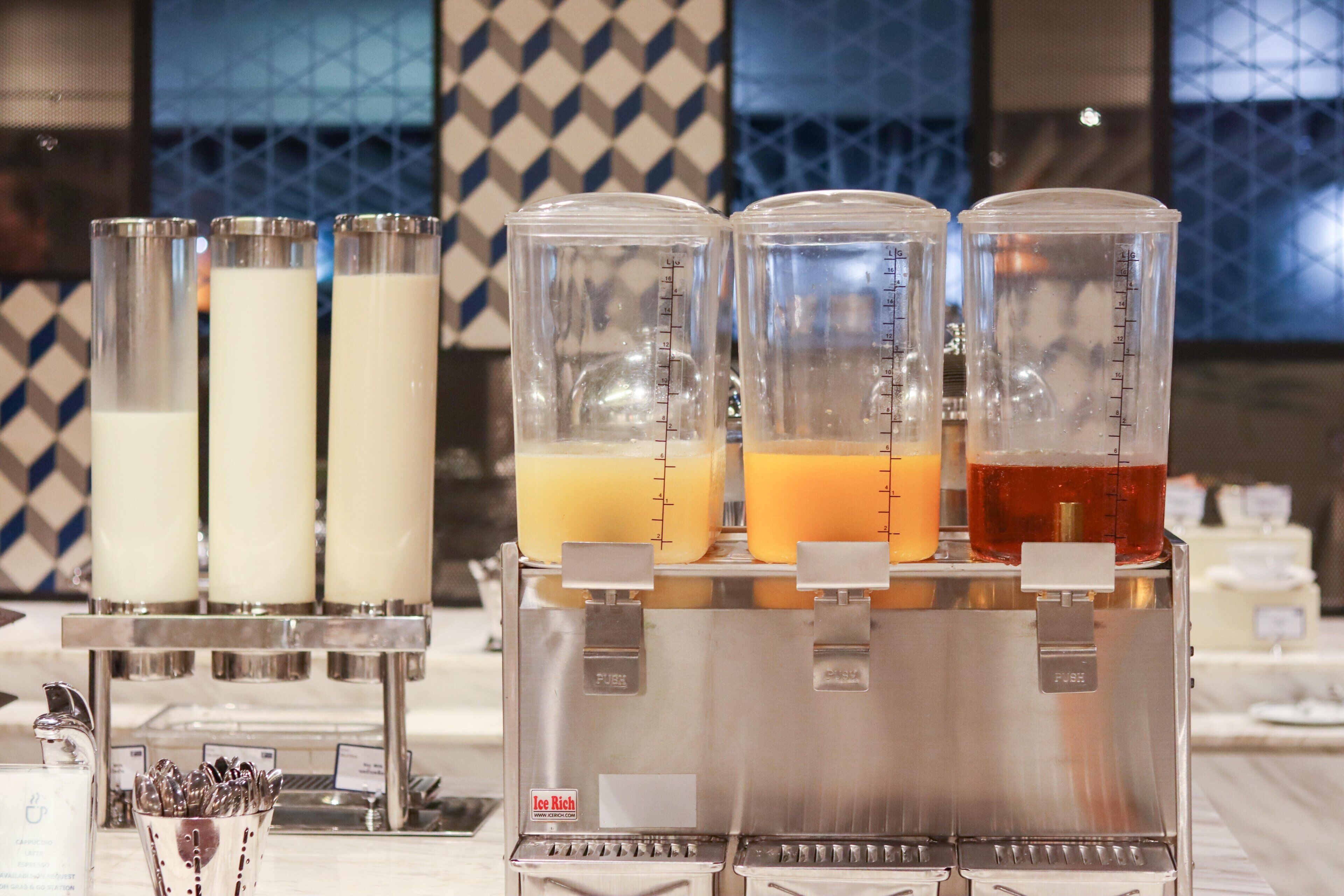 A beverage dispenser with multiple containers, each holding different drinks.