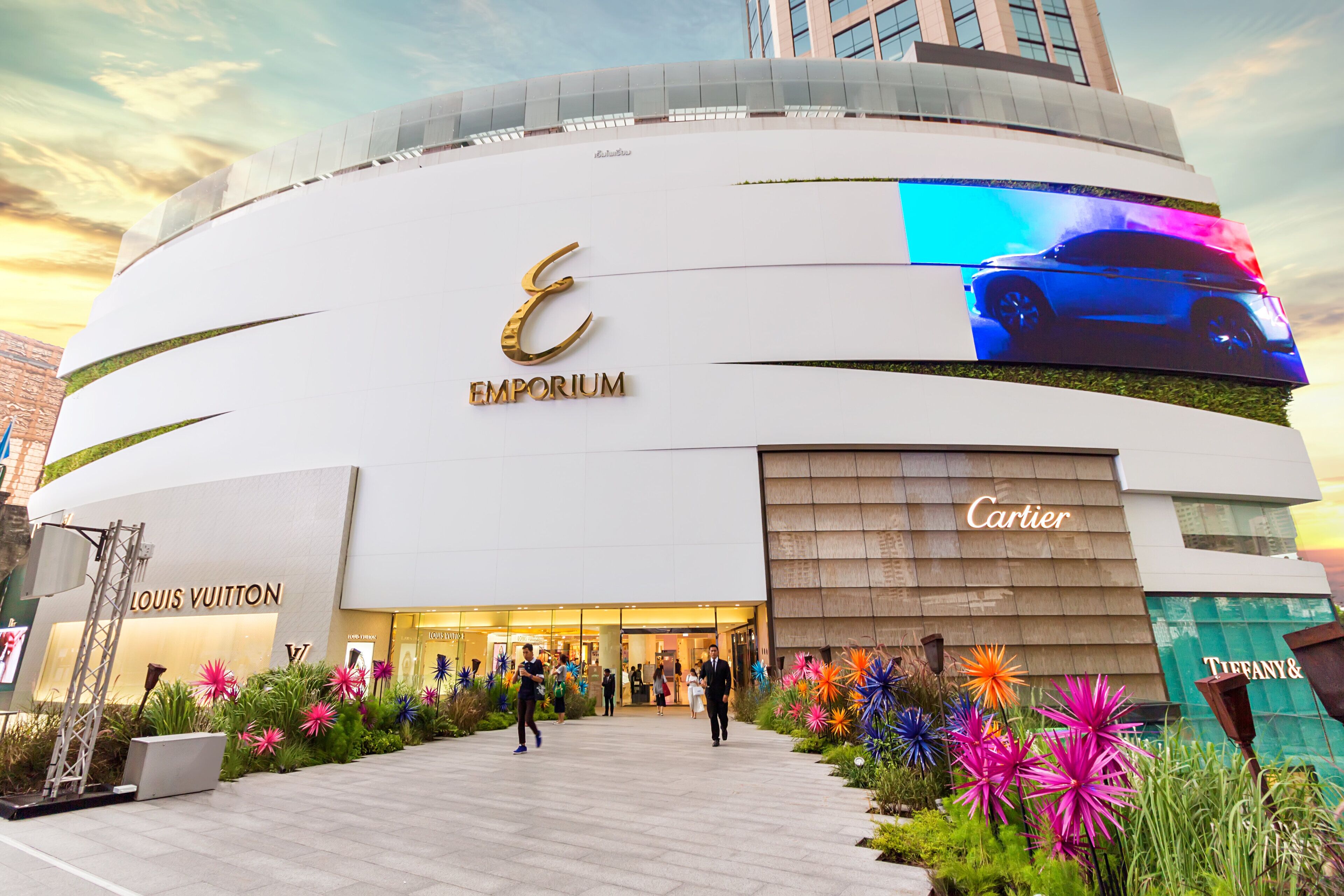 A modern building with the sign 'EMPORIUM' and 'Cartier' on the facade.
