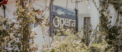 A sign with the word "Opera" and fish illustrations.