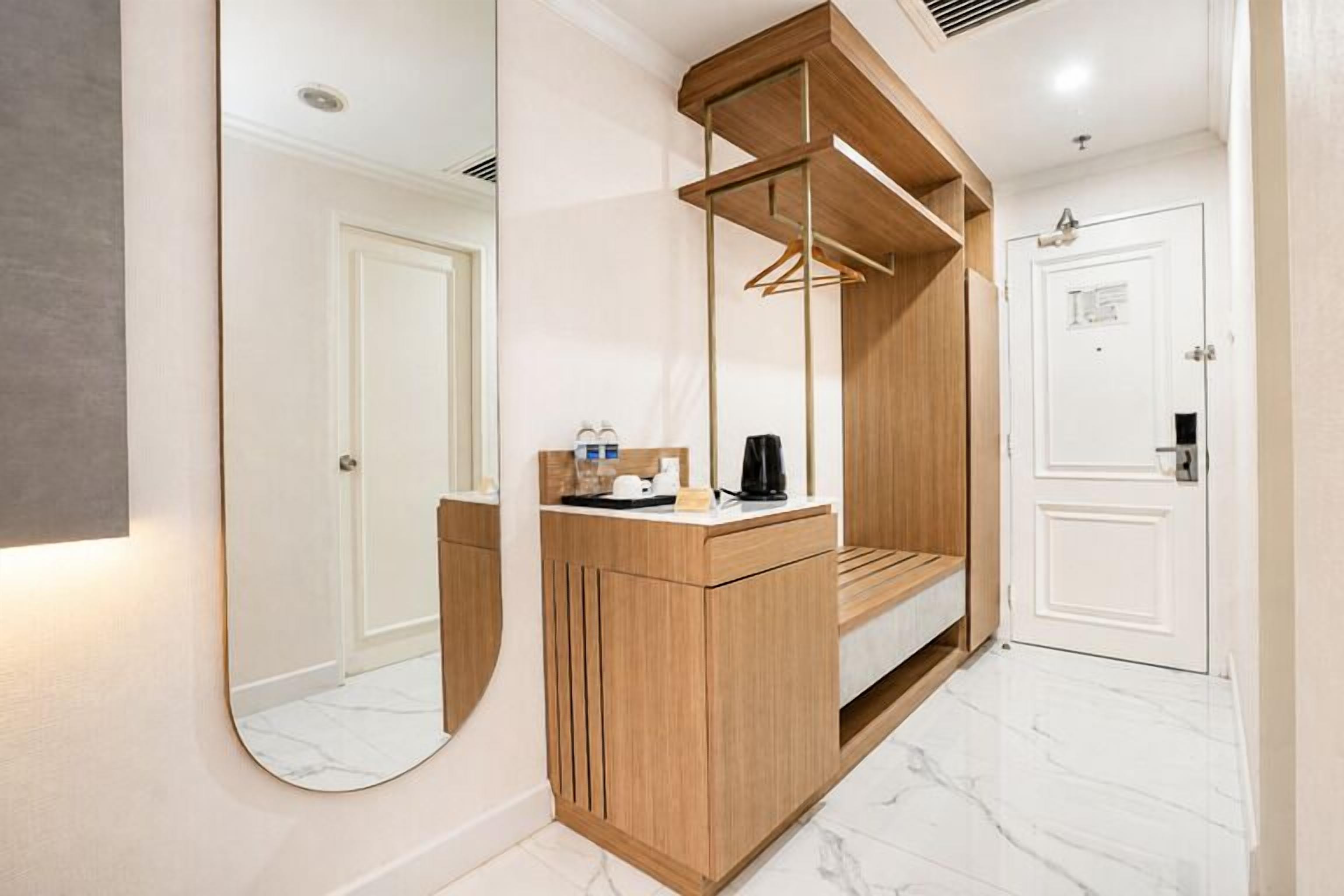 A modern bathroom with a wooden vanity, a large mirror, and a shower area.