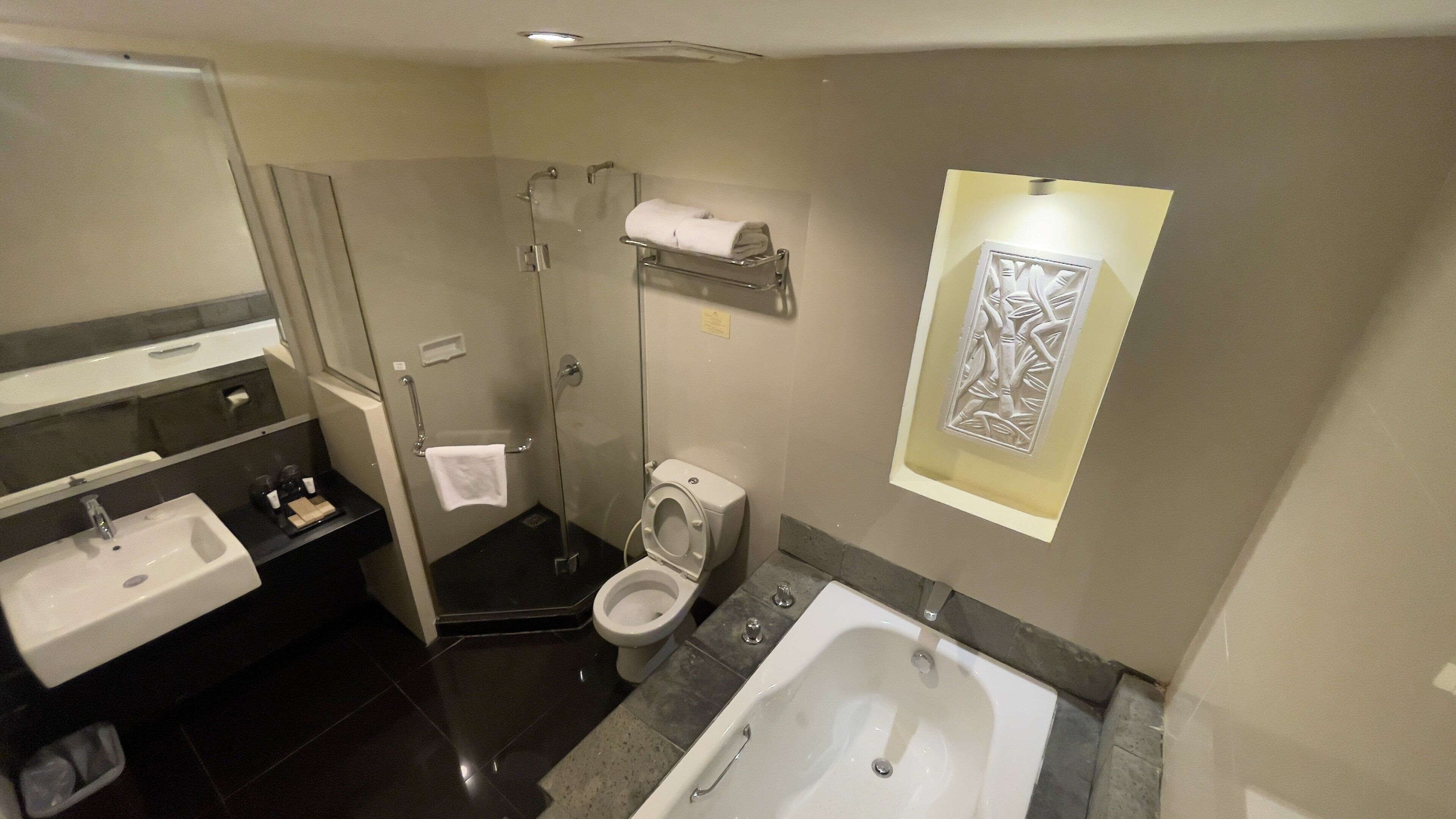 A bathroom with a sink, toilet, shower, and bathtub.