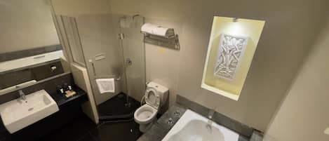 A bathroom with a sink, toilet, shower, and bathtub.