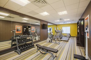 A gym with exercise equipment, a bench, and a mirror. - Holiday Inn Express & Suites Eureka by IHG (Eureka)
