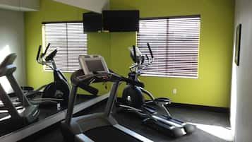 A gym with treadmills, an elliptical, and a stationary bike.