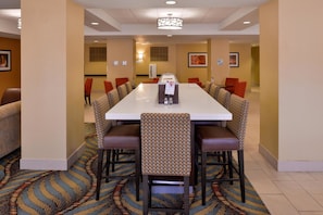 A conference room with a long table, multiple chairs, and a patterned carpet. - Holiday Inn Express & Suites Page - Lake Powell Area by IHG (Page)