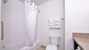 A bathroom with a bathtub, toilet, and a shower curtain. - Holiday Inn Express & Suites Page - Lake Powell Area by IHG (Page)