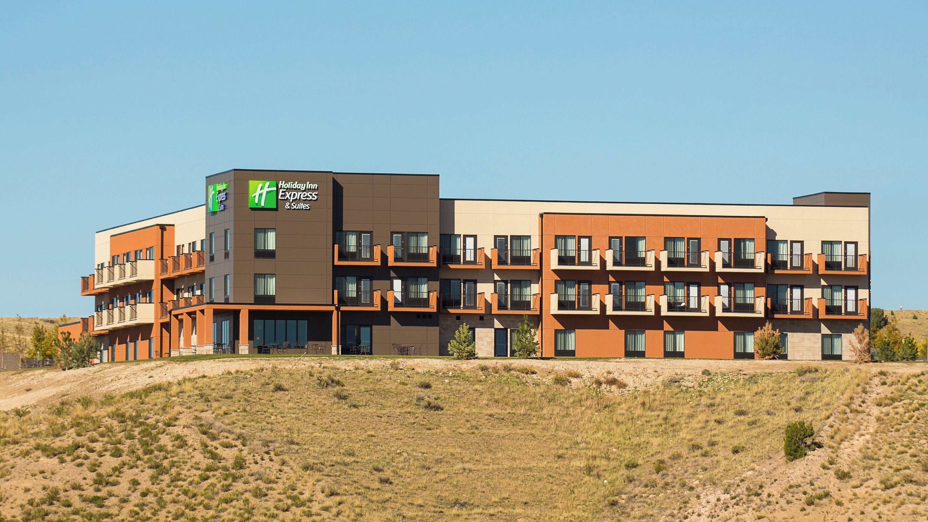 A multi-story hotel with a modern design, featuring balconies and large windows.