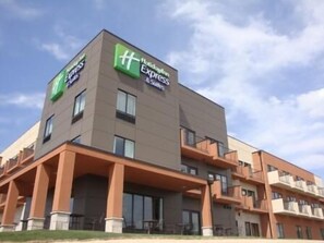 Un hôtel moderne, avec un toit plat et une enseigne indiquant qu’il s’agit d’un Holiday Inn Express.