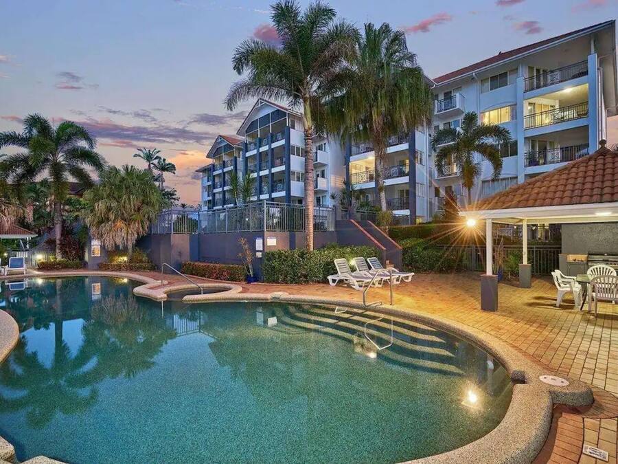 Una piscina al aire libre, sillones reclinables de piscina