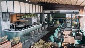 An outdoor bar area with seating and a counter. - Hotel Shambala (Kathmandu)