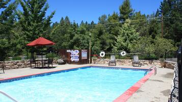 Seasonal outdoor pool, open 10:00 AM to 9:00 PM, pool umbrellas