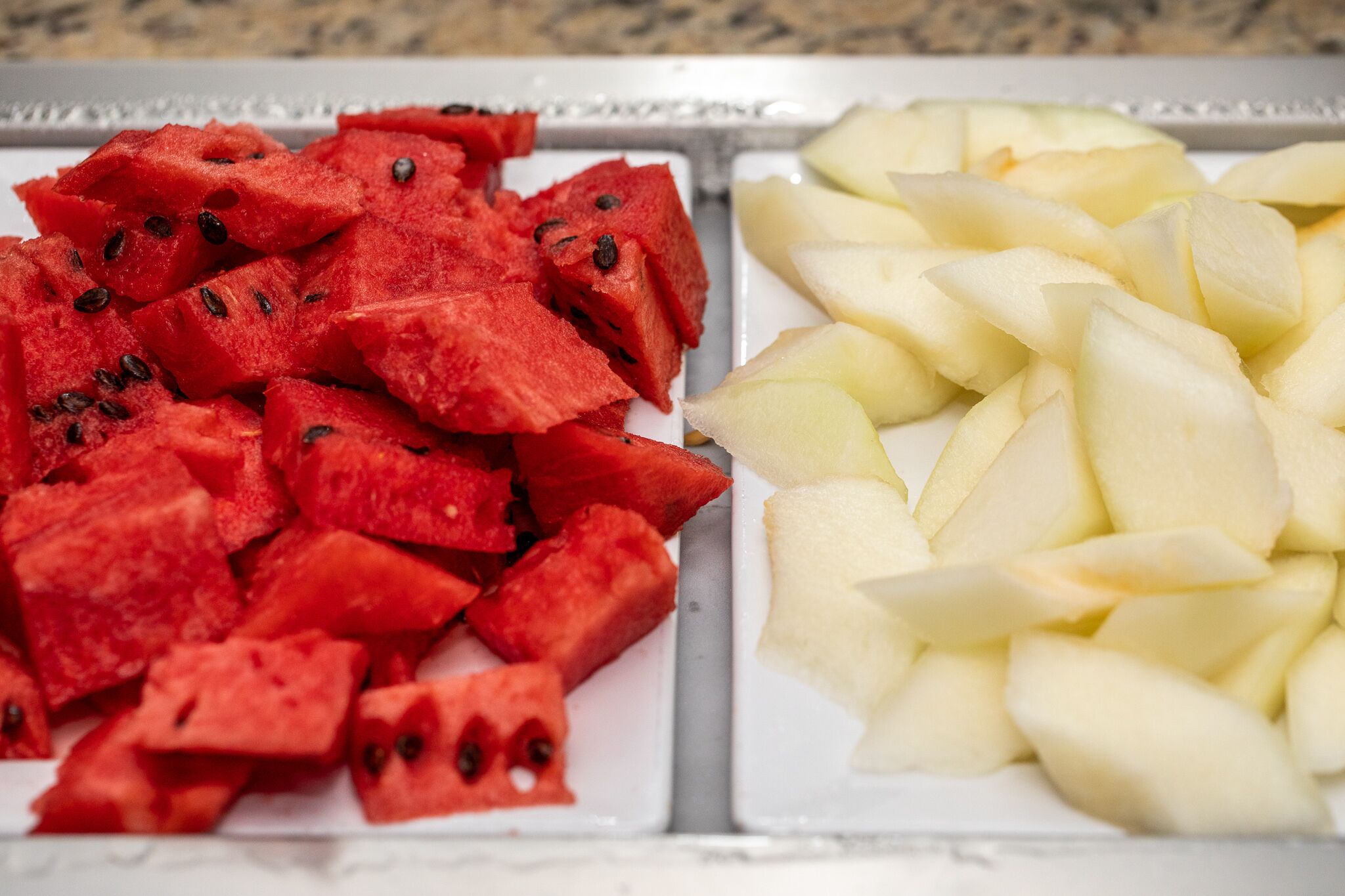 A tray with watermelon and apple slices.