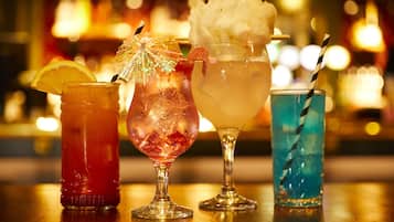 Four different cocktails on a bar counter.