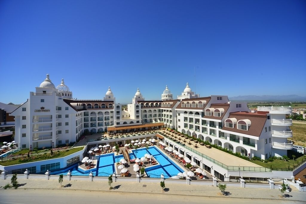 A large resort with multiple domed buildings, a central pool area, and outdoor seating.