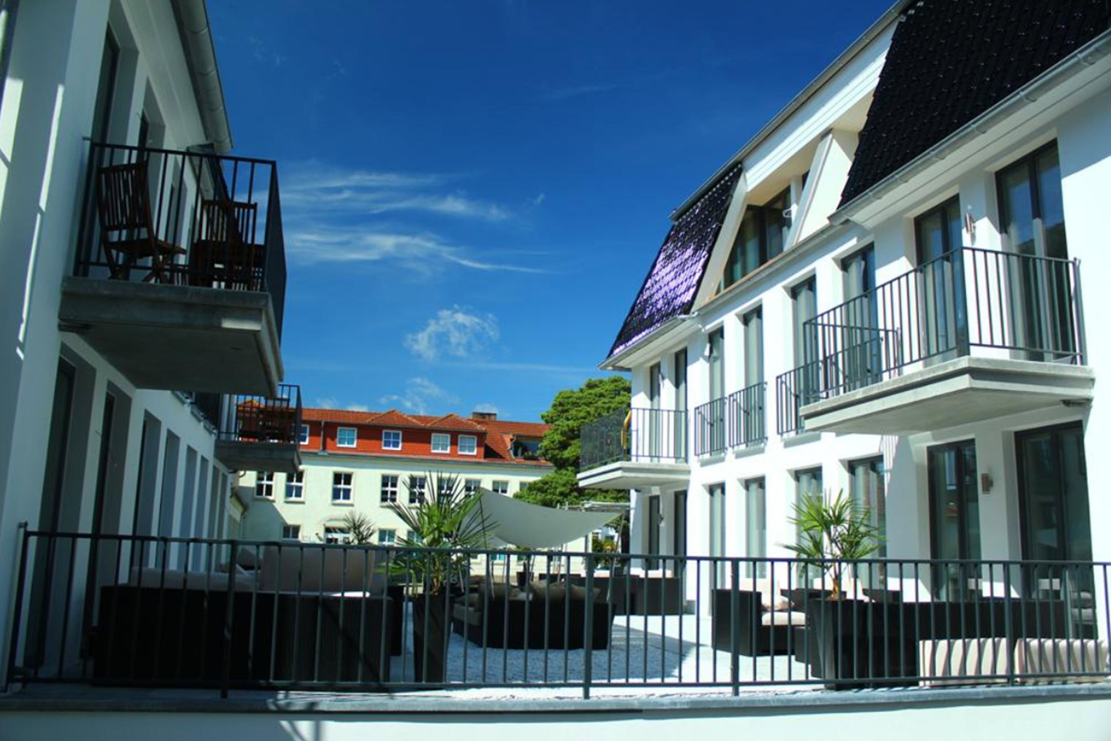 A modern building with balconies and large windows.