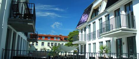 A modern building with balconies and large windows.