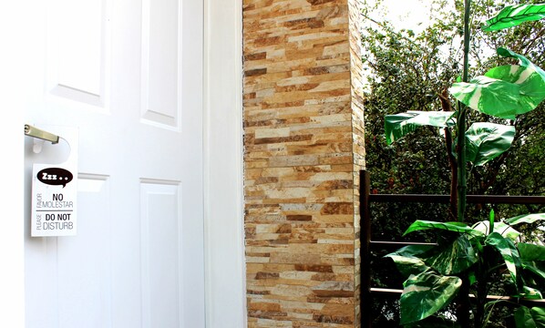 A white door with a sign that reads "No Molestor, Please Do Not Disturb."