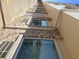 A rooftop with multiple skylights and a ventilation system.