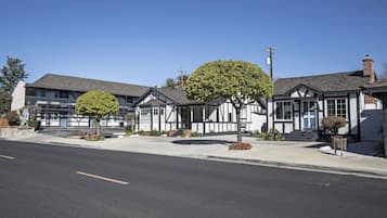 A row of two-story buildings with a central courtyard, featuring a mix of residential and commercial spaces.