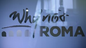 A glass window with the text "Why not ROMA" and a silhouette of a building. - Why Not Roma (Rome)