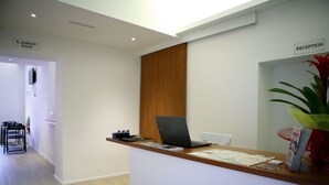 A reception desk with a laptop, a map, and a sign indicating the breakfast room. - Why Not Roma (Rome)