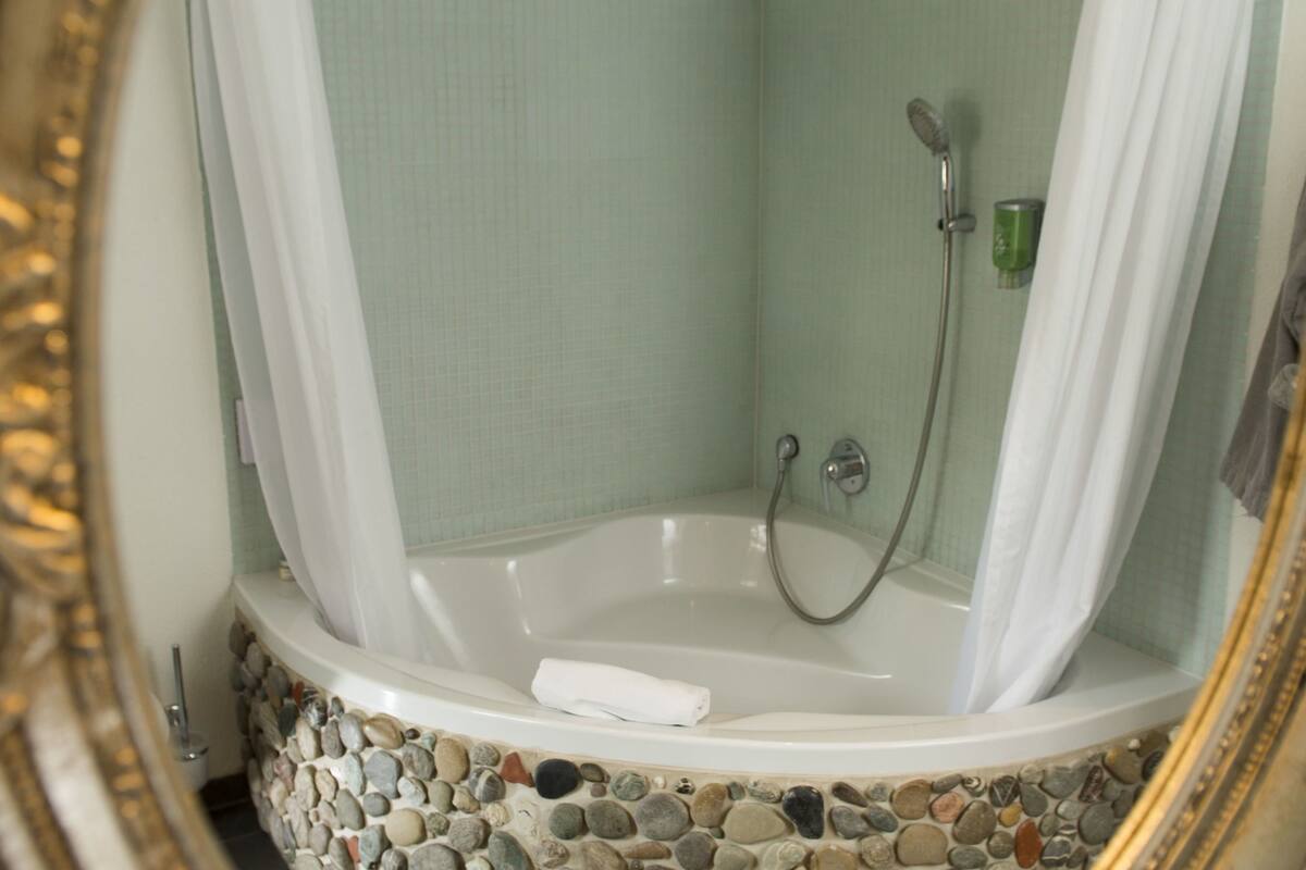 deluxe double room | bathroom | deep-soaking bathtub, hair dryer, dressing gowns, towels