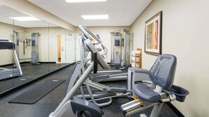 A gym with treadmills, weight machines, and a mirror wall. - Baymont by Wyndham Erie (Erie)