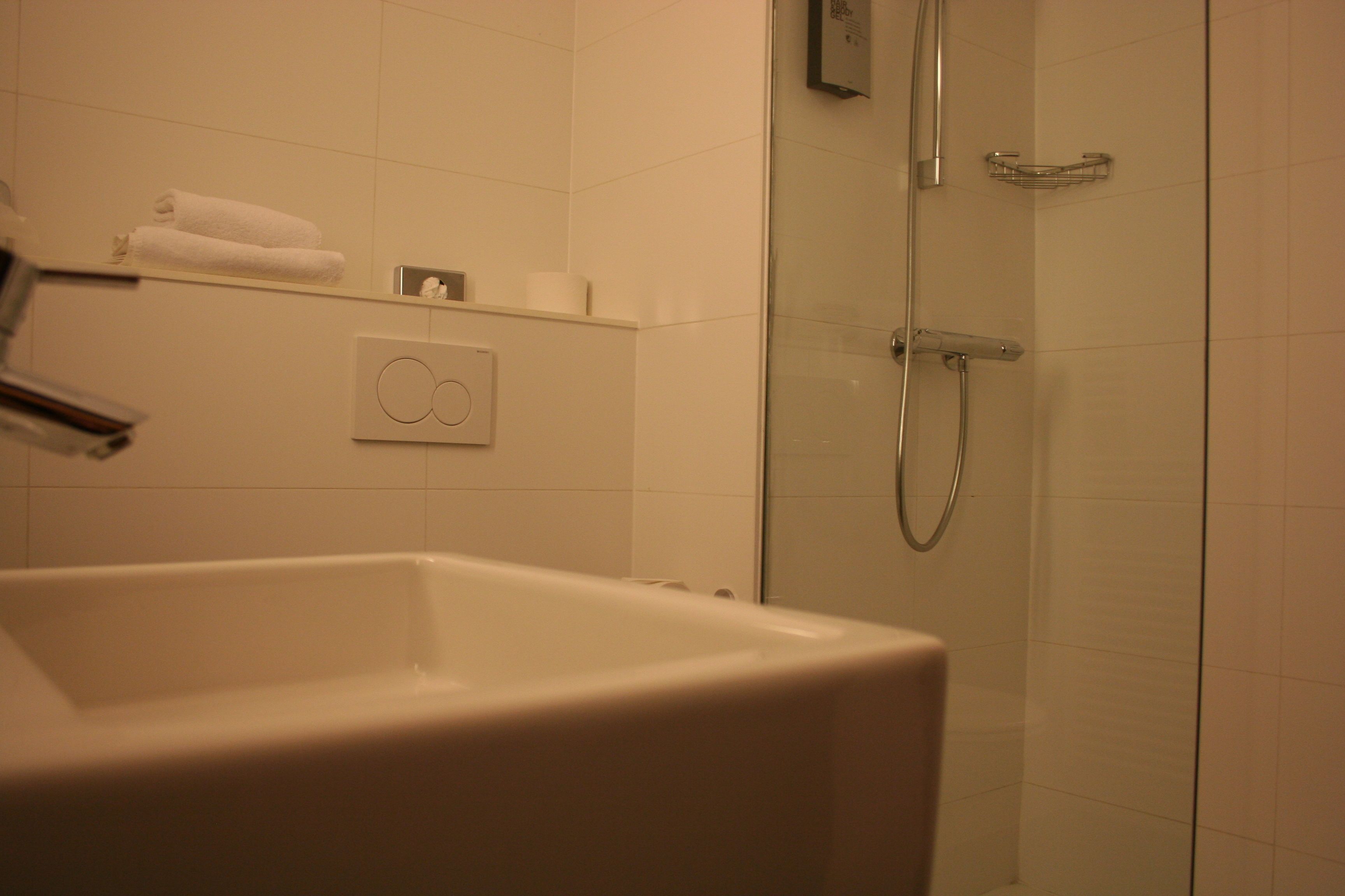 deluxe room | bathroom | shower, hair dryer, towels