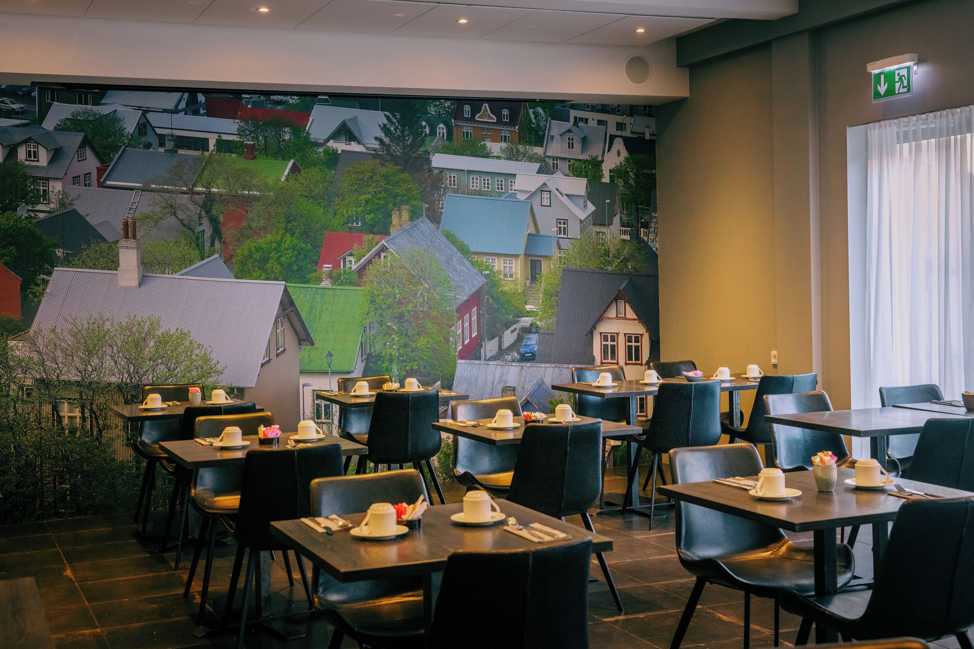 A restaurant with tables and chairs arranged for dining.