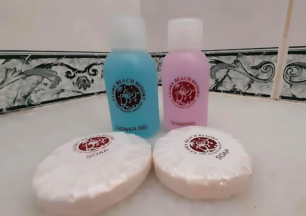 Three bottles of shower gel and two bars of soap.