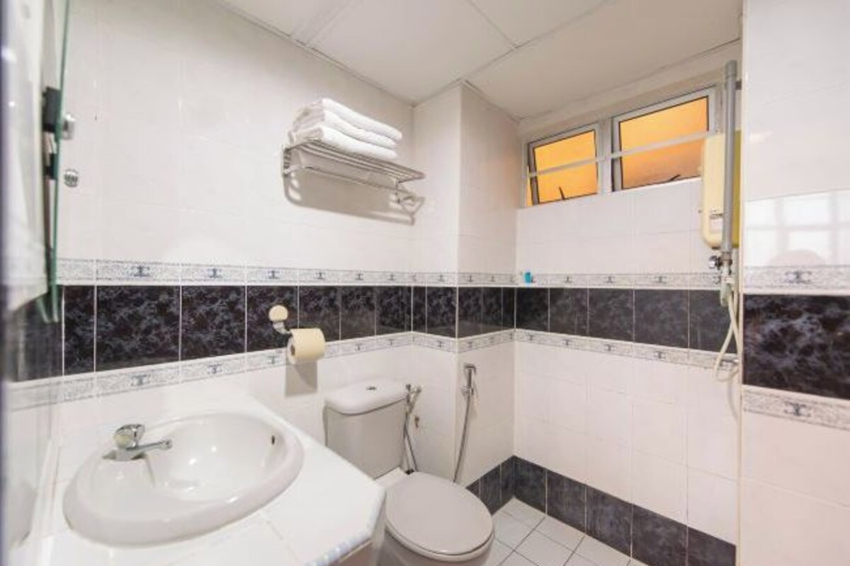 A bathroom with a sink, toilet, and shower.