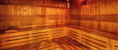 A sauna with wooden benches and a bench with a backrest.