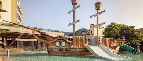 A pirate-themed water park with a ship-shaped slide and a tall tower structure.
