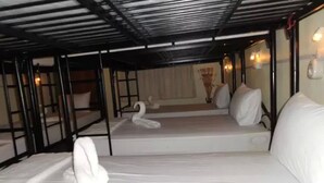 Une chambre d’hôtel avec un lit, un oreiller en forme de cygne et une fenêtre avec des rideaux.