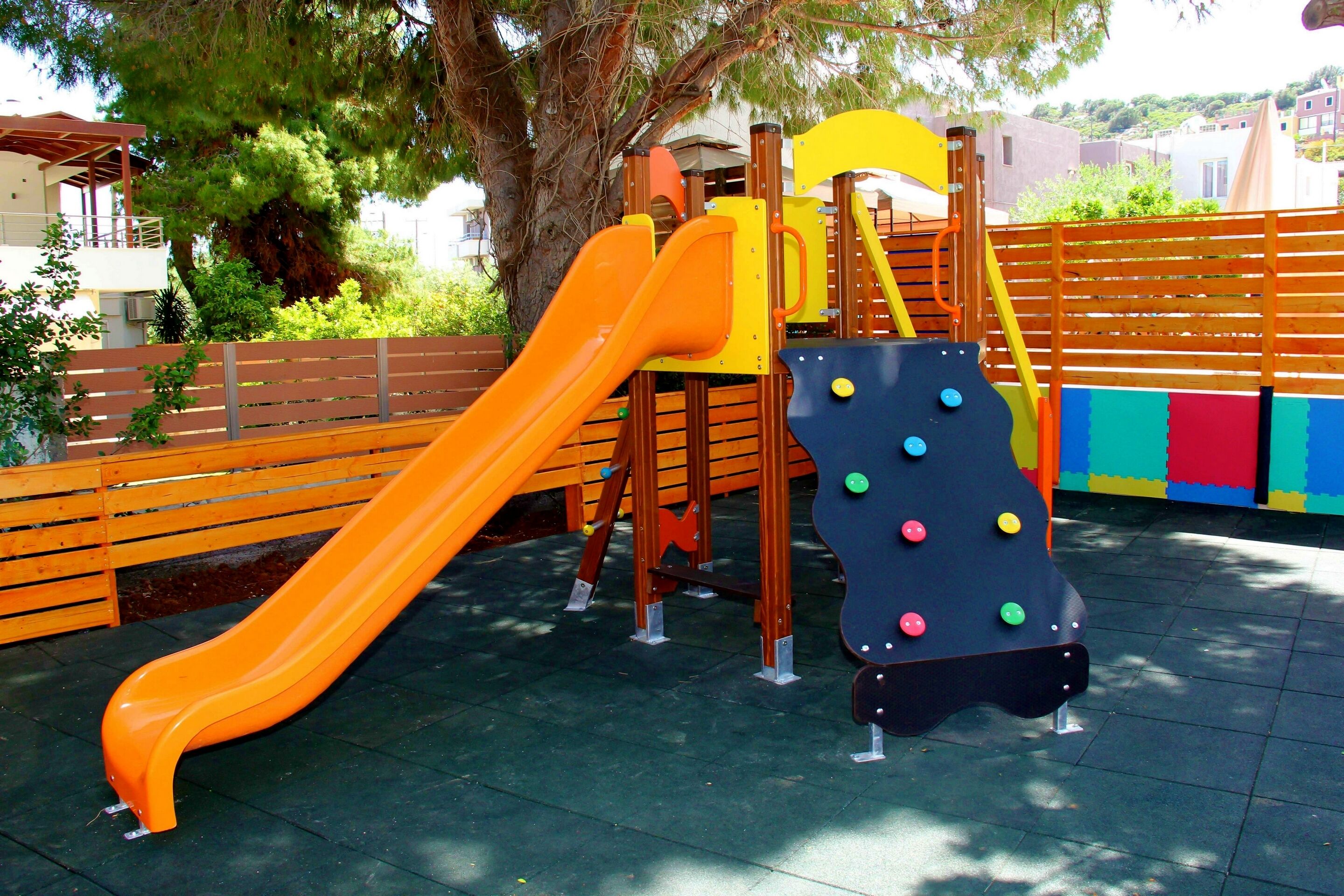 A playground with a slide and climbing structures.