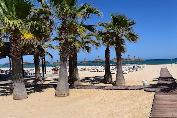 Private beach, white sand, sun loungers, beach umbrellas